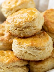 A collection of golden biscuits placed on a white napkin, representing the scrumptious recipes featured by Taste of Home.