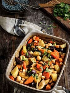 A colorful casserole dish brimming with carrots, potatoes, and various vegetables, representing a hearty home-cooked recipe.