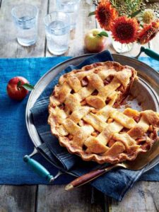 A freshly baked pie with a decorative lattice top, served on a plate, embodying the spirit of Taste of Home Recipes.